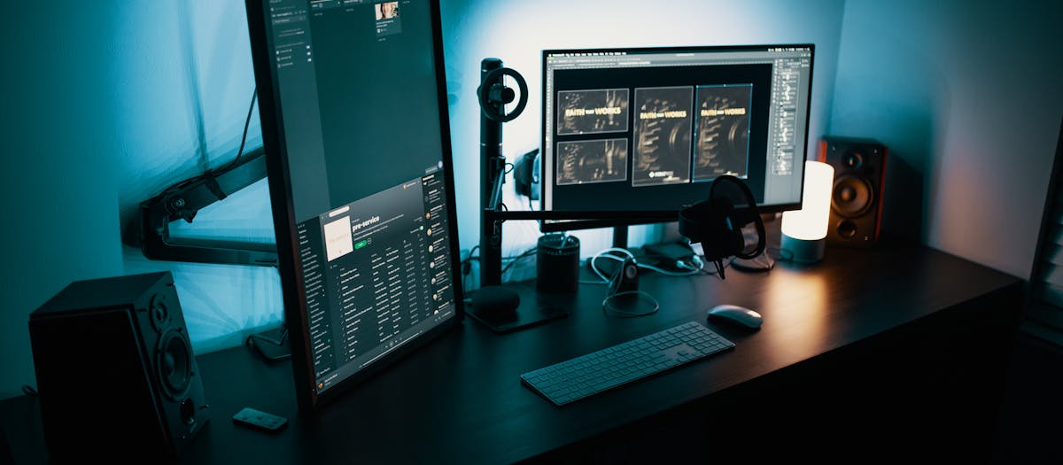 A contemporary office desk featuring a dual monitor setup with stylish lighting, ideal for tech enthusiasts.